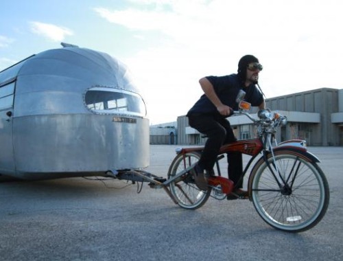 Man towing Airstream with Bike