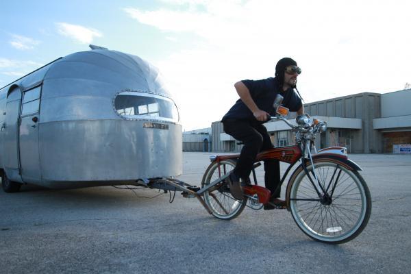Man towing Airstream with Bike