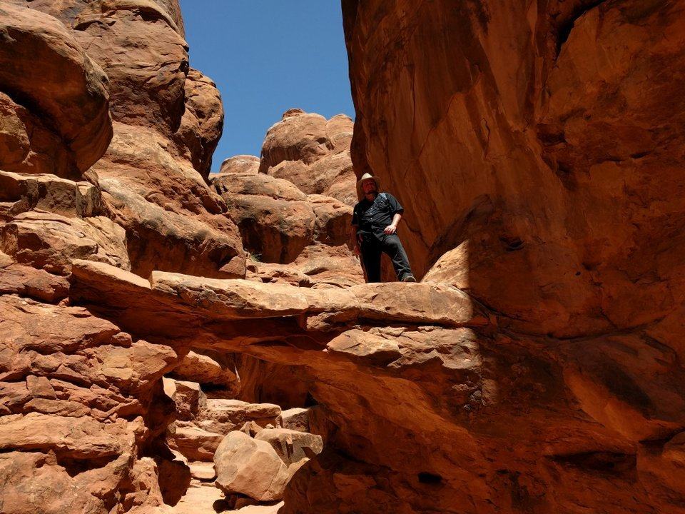 On a rock behind the arch