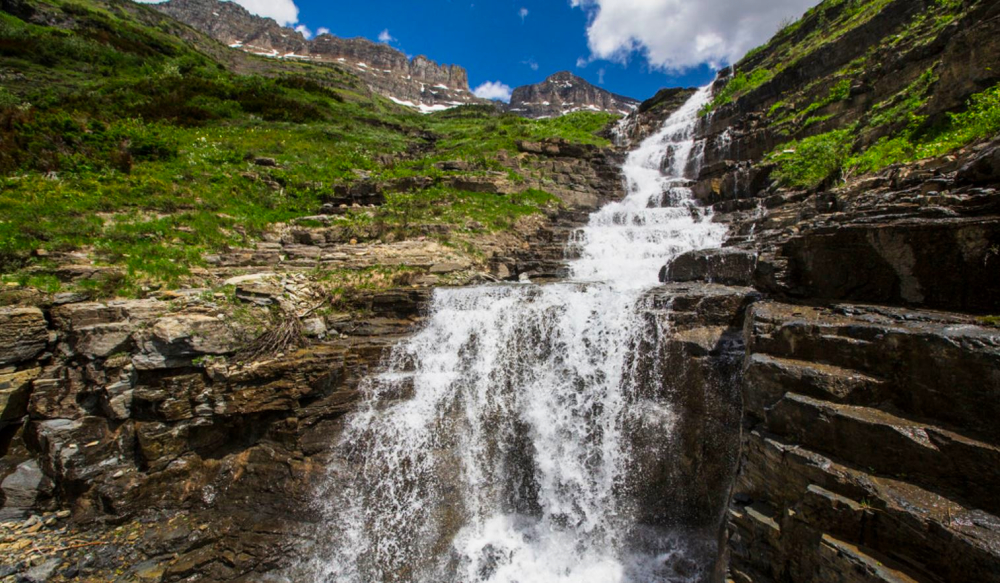 This beautiful waterfall cascades down the western side of the Garden Wall, and spills under a stone bridge.