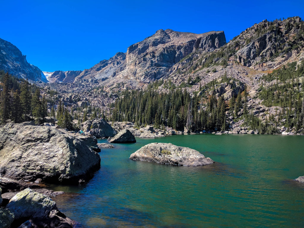 Dotted around shore hikers perch themselves atop huge and small boulders surrounding the lake. We pick a boulder and have our lunch.